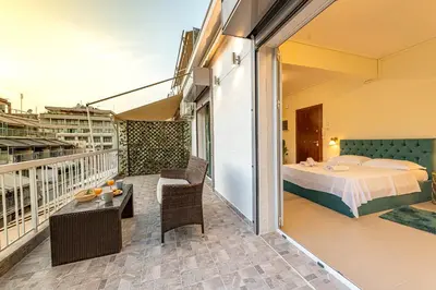 a room with a balcony with a bed and a bedroom at Athens Plaka House in Athens
