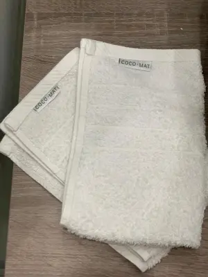 a white towel sitting on top of a table at Athens Plaka House in Athens