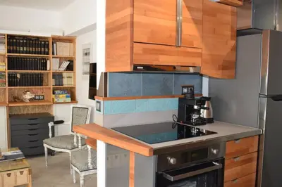 a kitchen with wooden cabinets and a stove top oven at h2h Myrto #Λειτουργικό studio 30' Αθήνα, 15' Αεροδρομιο in Athens