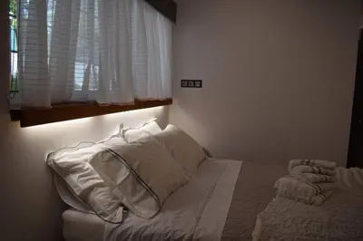 a bedroom with a bed with white pillows and a window at h2h Myrto #Λειτουργικό studio 30' Αθήνα, 15' Αεροδρομιο in Athens