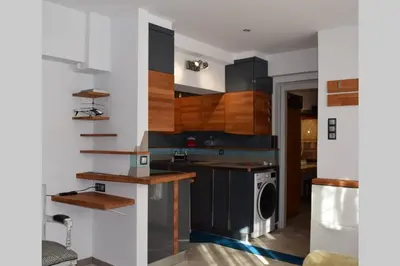 a kitchen with wooden shelves and a stove at h2h Myrto #Λειτουργικό studio 30' Αθήνα, 15' Αεροδρομιο in Athens