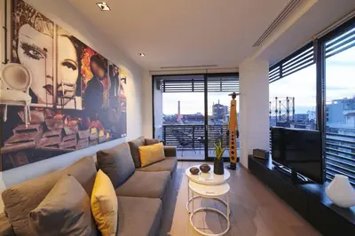 a living room with a couch and a tv at Ma Maison No4,Downtown Loft,360Mbps,Acropolis walk in Athens