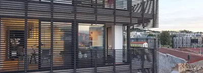 a building with wooden blinds on a roof at Ma Maison No4,Downtown Loft,360Mbps,Acropolis walk in Athens