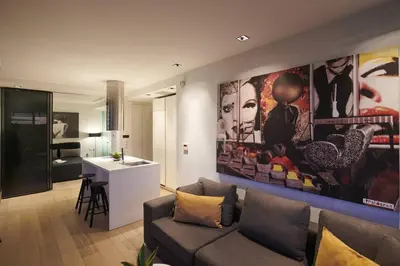 a living room with a couch and a large painting on the wall at Ma Maison No4,Downtown Loft,360Mbps,Acropolis walk in Athens