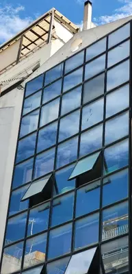 an office building with windows reflecting the sky at Driopon Apartment - Penthouse in Athens