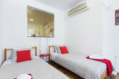 a room with two beds with red pillows at Driopon Apartment - Penthouse in Athens