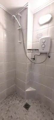 a bathroom with a shower with a mirror at Driopon Apartment - Penthouse in Athens