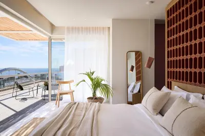 a bedroom with a large bed and a balcony at Sea View Beach Penthouse - Athens Coast in Athens