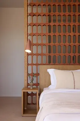 a bedroom with a headboard and a bed and a table at Sea View Beach Penthouse - Athens Coast in Athens