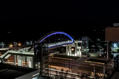 a blue bridge on top of a building at night at Sea View Beach Penthouse - Athens Coast in Athens
