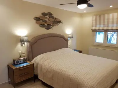 a bedroom with a bed and a clock on the wall at Casa Denva in Kalívia Thorikoú