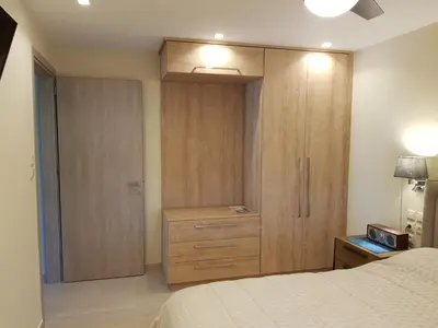 a bedroom with a bed and a dresser and a closet at Casa Denva in Kalívia Thorikoú