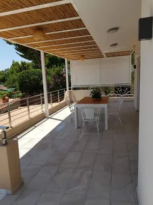 a patio with a table and chairs on it at Casa Denva in Kalívia Thorikoú