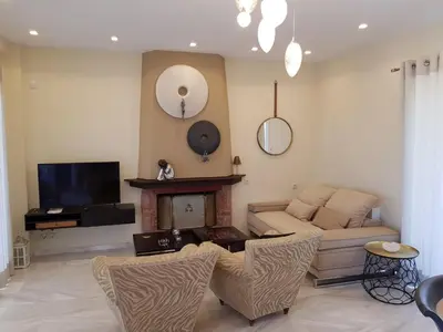 a living room with a couch and a fireplace at Casa Denva in Kalívia Thorikoú