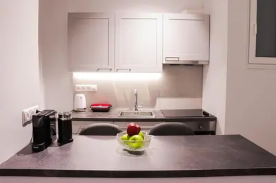 a kitchen with a bowl of fruit on a counter at Zea Apartments in Piraeus