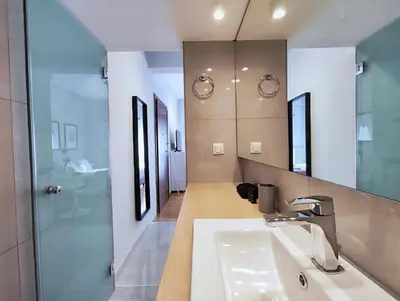 a bathroom with a sink and a mirror at Zea Apartments in Piraeus