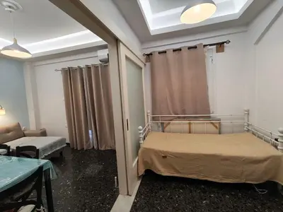 a hospital room with a bed and a window at Freatida apartment in Piraeus