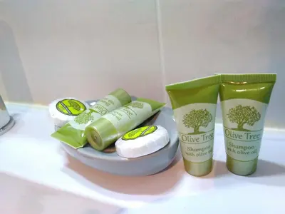 two bottles of olive tree products sitting on a counter at Freatida apartment in Piraeus