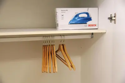 a room with a table with a box on a shelf at Freatida apartment in Piraeus
