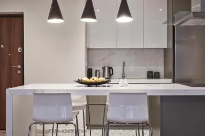 a kitchen with a counter with chairs and a bowl of fruit at Charitos IΧ, Chic n modern 2BD Apt in Athens