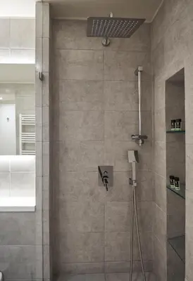 a bathroom with a shower with a glass door at Charitos IΧ, Chic n modern 2BD Apt in Athens