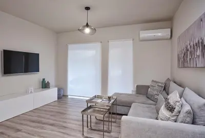 a living room with a couch and a tv at Charitos IΧ, Chic n modern 2BD Apt in Athens