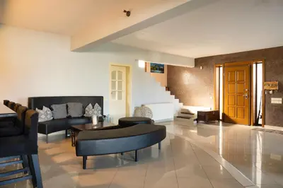 a living room with a couch and a table at Villa Sofia in Anavissos
