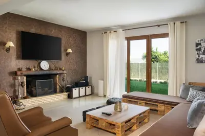 a living room with a couch and a fireplace at Villa Sofia in Anavissos