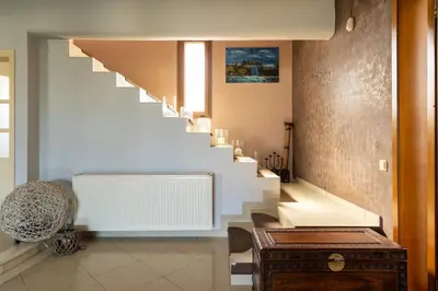a staircase in a house with a stair case at Villa Sofia in Anavissos