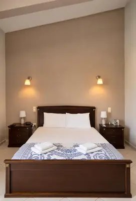 a bedroom with a bed with two towels on it at Villa Sofia in Anavissos