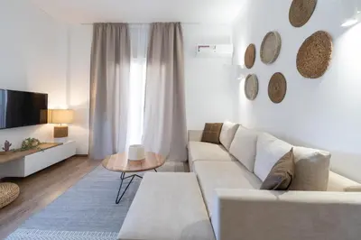 a living room with a couch and a table at Urban Boho apartment in Koukaki in Athens
