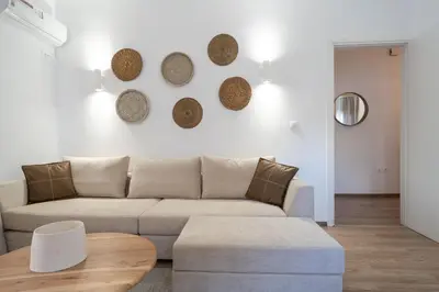 a living room with a couch and a table at Urban Boho apartment in Koukaki in Athens