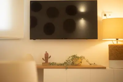 a flat screen tv hanging on a wall at Urban Boho apartment in Koukaki in Athens