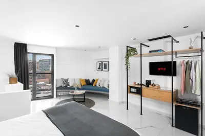 a bedroom with a bed and a tv in a room at Melo Athens in Athens
