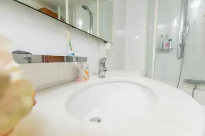 a white bathroom with a sink and a mirror at Filoxenia MG Kolonaki Athens in Athens