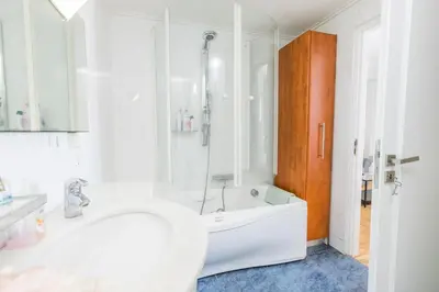 a white bathroom with a tub and a shower at Filoxenia MG Kolonaki Athens in Athens