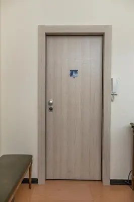 a wooden door in a room with a bench at Filoxenia MG Kolonaki Athens in Athens
