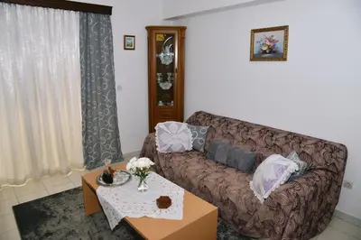 a living room with a couch and a table at TRADITIONAL HOUSE in Athens