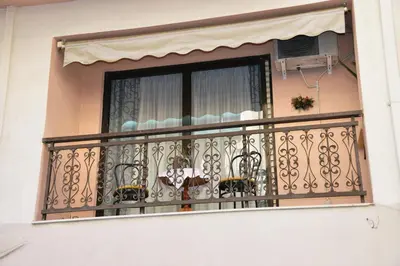 a balcony of a house with a window at TRADITIONAL HOUSE in Athens