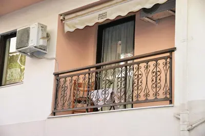 a balcony with a window and a air conditioner at TRADITIONAL HOUSE in Athens