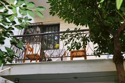 a balcony with two chairs and a table on it at TRADITIONAL HOUSE in Athens