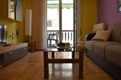 a living room with a couch and a coffee table at Colourful Apartment in AthensCity 1min from Subway in Athens