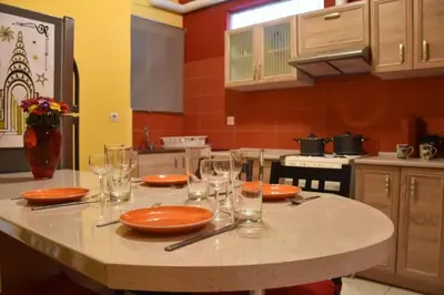 a kitchen with a table with plates and glasses on it at Colourful Apartment in AthensCity 1min from Subway in Athens