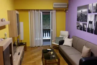 a living room with a couch and a table at Colourful Apartment in AthensCity 1min from Subway in Athens