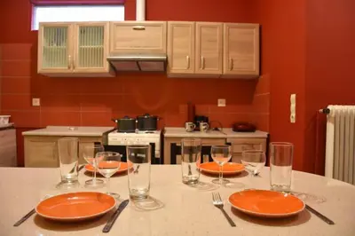 a table with orange plates and glasses on it at Colourful Apartment in AthensCity 1min from Subway in Athens