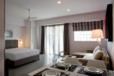 a bedroom with a bed and a living room at SYNATHENS APARTMENTS & STUDIOS in Athens