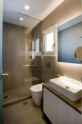 a bathroom with a sink and a toilet and a shower at SYNATHENS APARTMENTS & STUDIOS in Athens