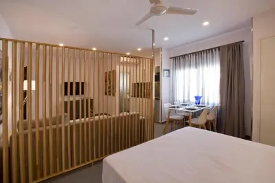 a bedroom with a bed and a dining room with a table at SYNATHENS APARTMENTS & STUDIOS in Athens