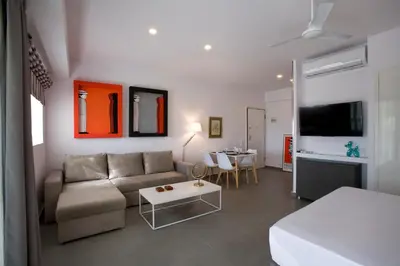 a living room with a couch and a table at SYNATHENS APARTMENTS & STUDIOS in Athens