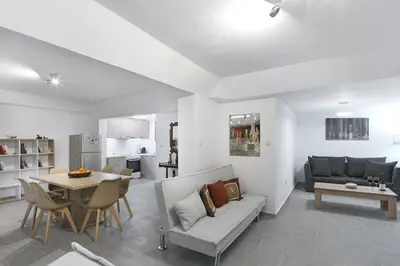 a living room with a couch and a table at 2 bedroom aprtmnt next to Hilton and all hospitals in Athens